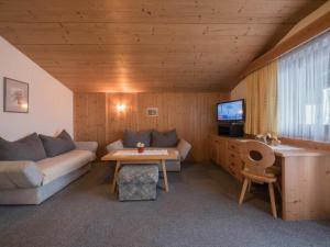 a living room with a couch and a tv at Ferienwohnungen Egger in Fügen