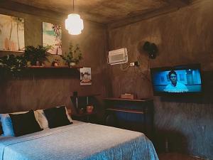 a bedroom with a bed and a tv in it at SUMMER STAY A Starlink in General Luna