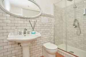 a bathroom with a sink and a toilet and a mirror at Villa laura in Palermo