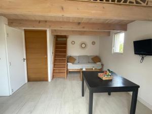 a living room with a couch and a table at Logement avec terrasse in Cogolin