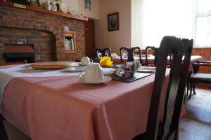 a dining room with a table with a pink table cloth at Rockville House B&B in Ballyshannon +33 photos