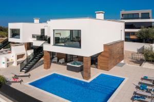 a house with a swimming pool in front of it at Villa Old Olive IV - Heated Pool - by Vivi Rent in Vodnjan