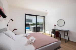a bedroom with a bed and a desk with a mirror at Villa Old Olive IV - Heated Pool - by Vivi Rent in Vodnjan +42 photos