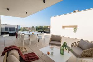 a patio with a table and chairs on a roof at Villa Old Olive IV - Heated Pool - by Vivi Rent in Vodnjan