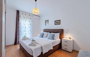 a bedroom with a large bed with white sheets and blue pillows at Villa Rania - Korcula by Villas Guide in Blato