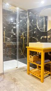 a bathroom with a sink and a glass shower at L'appart Cassis in Cassis +55 photos