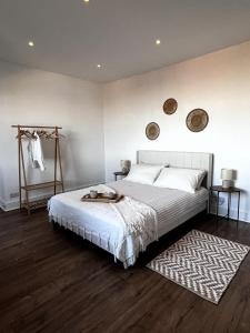 a bedroom with a large bed and a rug at Dine with the Sunset - Central Folkestone Gem in Folkestone