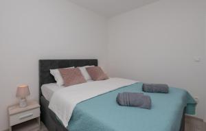 a bed with two pillows on top of it at Villa Petar Zagvozd - Makarska by Villas Guide in Zagvozd +50 photos