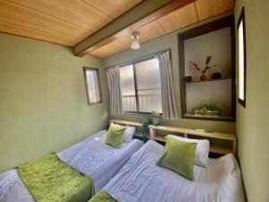 Un ou plusieurs lits dans un hébergement de l'établissement Momodani 72 two-story detached house