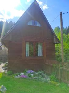 a wooden house with a window and a fence at Chata pre hostí s ohniskom in Spišská Nová Ves