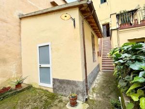 a building with a door and a window and plants at La Terrazza di San Salvi in Florence