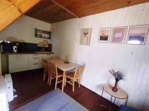 a kitchen and dining room with a table and chairs at Chata pre hostí s ohniskom in Spišská Nová Ves