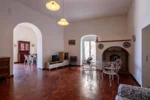 a living room with a table and chairs and a fireplace at Casa sul Mare by Rentbeat in Vieste
