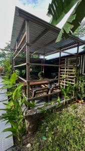 a house with a picnic table in front of it at Ying Yang House Catangnan in General Luna +18 photos