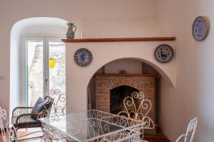 a dining room with a fireplace with plates on the wall at Casa sul Mare by Rentbeat in Vieste