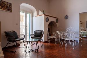 a dining room with chairs and a table and a fireplace at Casa sul Mare by Rentbeat in Vieste +59 photos