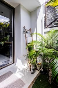 a porch with plants sitting next to a door at TownHouse6 2BR MonkeyHill in Ban Sam Kong