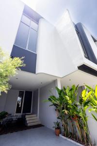a white house with plants in front of it at TownHouse6 2BR MonkeyHill in Ban Sam Kong +21 photos