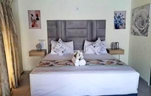 帕拉博鲁瓦Glamour C-rane lodge的坐在床上的白泰迪熊