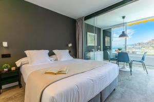 a bedroom with a large bed with a book on it at Doñana 1006 by VillaGranCanaria in Mogán