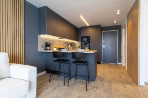 a kitchen with a counter and stools in a room at Doñana 1006 by VillaGranCanaria in Mogán