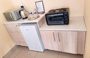 a microwave sitting on top of a counter in a kitchen at Glamour C-rane lodge in Phalaborwa