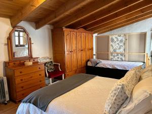 a bedroom with a bed and a dresser and a mirror at Casa rural La Bodega in Castell de Ferro