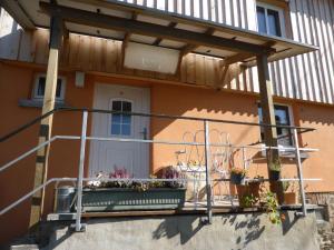 a balcony of a house with a flower box at Upcycling Ferienhaus in Roth +6 photos