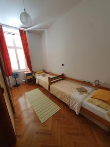 a room with two beds and a large window at Apartment Goga in Cres