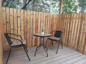 a table and two chairs on a wooden deck at Emilie Guest House in Haifa