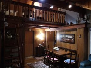 a dining room with a wooden table and chairs at Appartamento 19 Nigritella in Sappada
