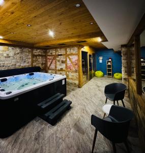a jacuzzi tub in a room with chairs at KABAN BOUTIQUE HOTEL - 5Star Central Villa in Vatra Dornei in Vatra Dornei
