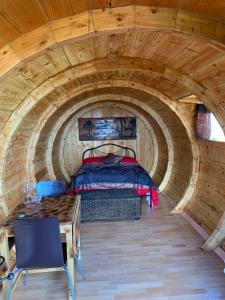 a room with a bed and a table in a tunnel at PinoPerdido Olías Málaga in Málaga