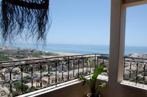 a balcony with a view of the ocean at SurfAppart Morocco in Tamraght Ouzdar