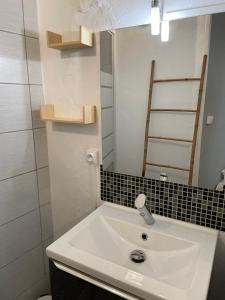 a bathroom with a white sink and a mirror at Le Charme Provençal - Centre-ville - Calme in Digne-les-Bains