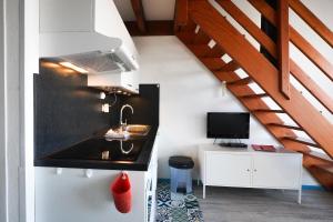 Μια τηλεόραση ή/και κέντρο ψυχαγωγίας στο Appartement en duplex 2* Résidence Les Pêcheurs