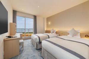Postel nebo postele na pokoji v ubytování KAMENOI HOTEL Kujukuri