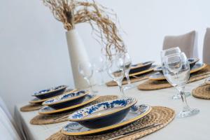 a table with plates and wine glasses on it at Prizba Tomas 1 in Blato +35 photos