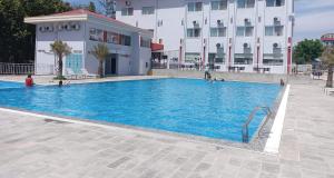 a large swimming pool in front of a building at Lumbini Green Hotel in Namāi
