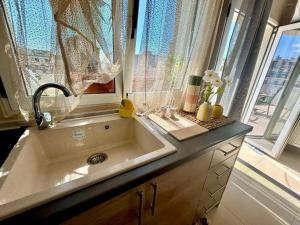 a bathroom with a sink and a window at Alpha Apartment View in Serres +23 photos