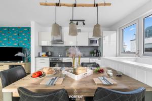 a kitchen with a wooden table with food on it at Ferienhaus Am Pier Olpenitz in Olpenitz