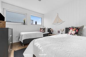 a bedroom with two beds and a window at Ferienhaus Am Pier Olpenitz in Olpenitz