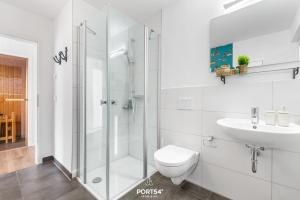 a bathroom with a shower and a toilet and a sink at Ferienhaus Am Pier Olpenitz in Olpenitz