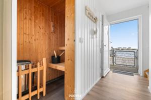 a room with a wooden wall with a desk and a window at Ferienhaus Am Pier Olpenitz in Olpenitz +40 photos