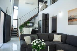 a living room with a couch and a staircase at Emma - Elena Peris Villas, By Idealstay Experience in Gouves
