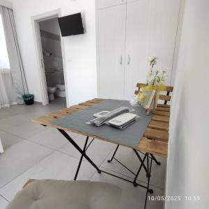 a wooden table in a white room with at KipoRooms in Zollino
