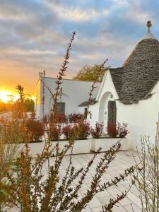 a small white building with a roof at I Trulli e la Luna in Alberobello