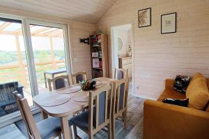 a dining room with a table and chairs at Arkadia Borzestowo in Borzestowo
