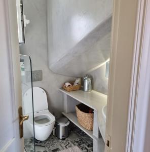 a small bathroom with a toilet and a sink at MARINA'S HOUSE - Serenity in Poros +11 photos