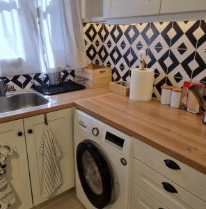 a kitchen with a washing machine and a sink at MARINA'S HOUSE - Serenity in Poros